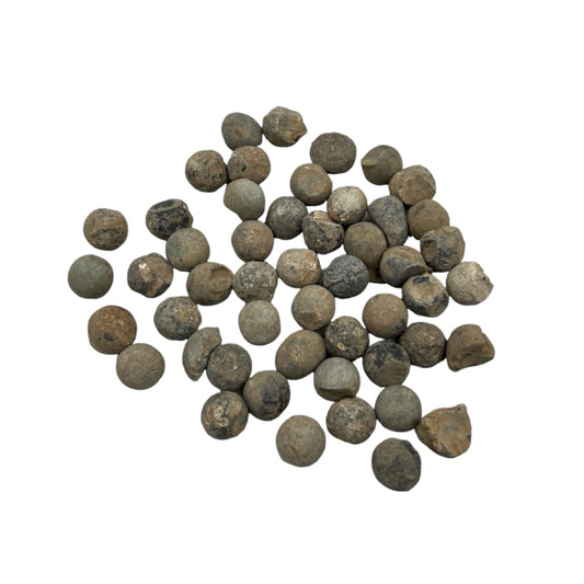 A collection of 50 black shrapnel balls from WW1, displayed against a white background.