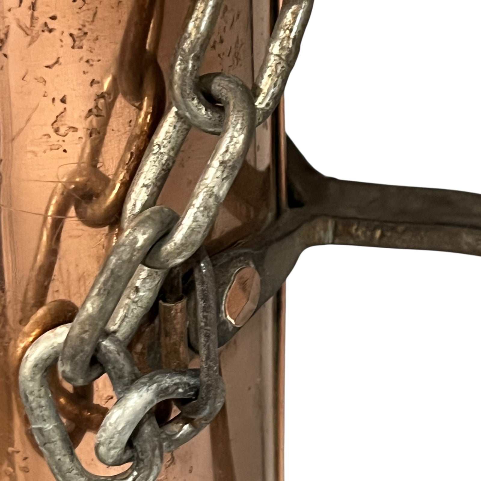 Close-up of a copper milk churn with a chain handle on a white background