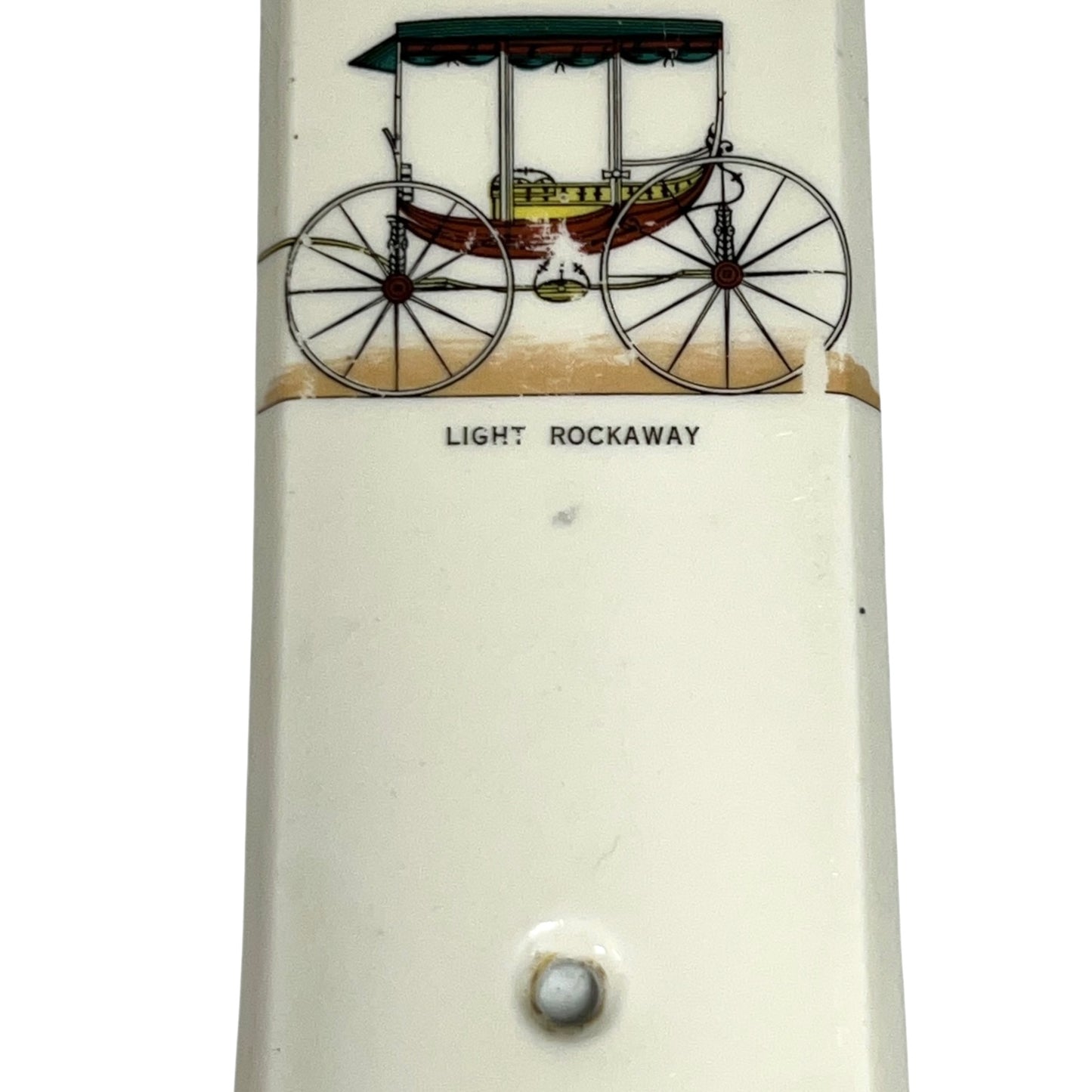 Close up of fingerplate with vintage car illustrations on a white background