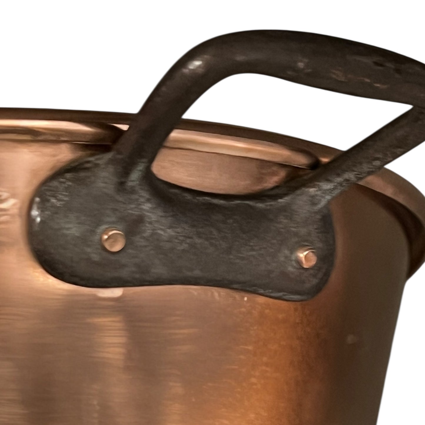 Close up of French copper bowl upcycled into a copper sink with cast iron handles on a white background
