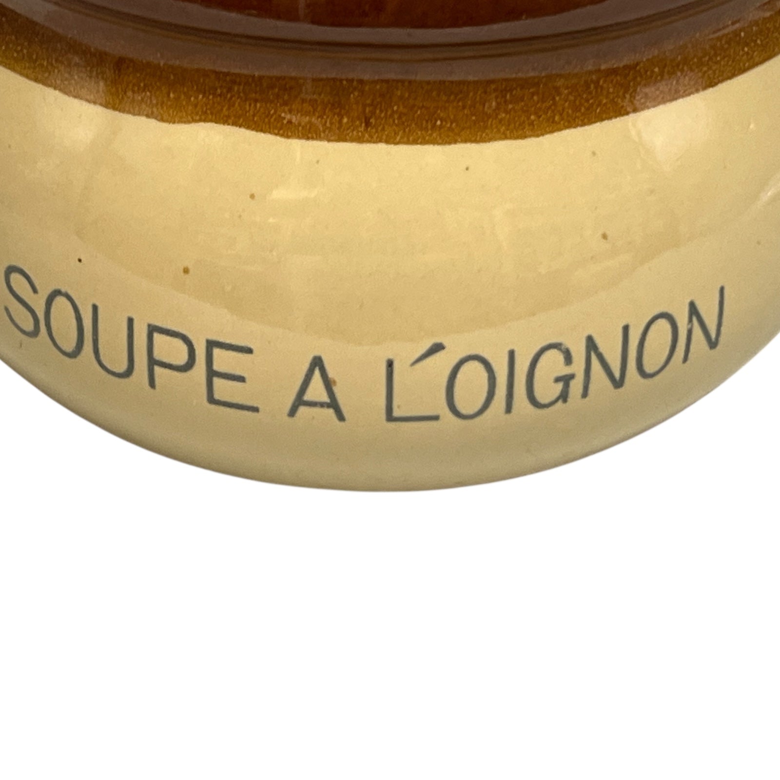 Close-up of a ceramic soup bowl with 'Soupe a L'Oignon' text on a white background