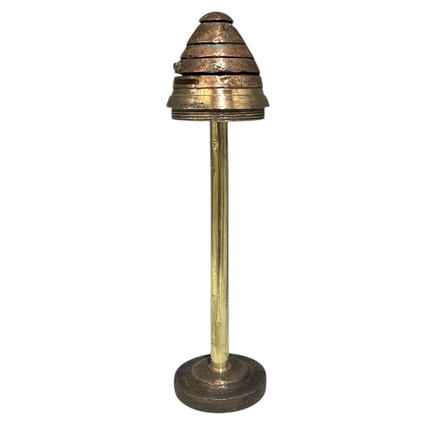 WW1 brass fuse on a all brass pipe attached to a solid base on a white background