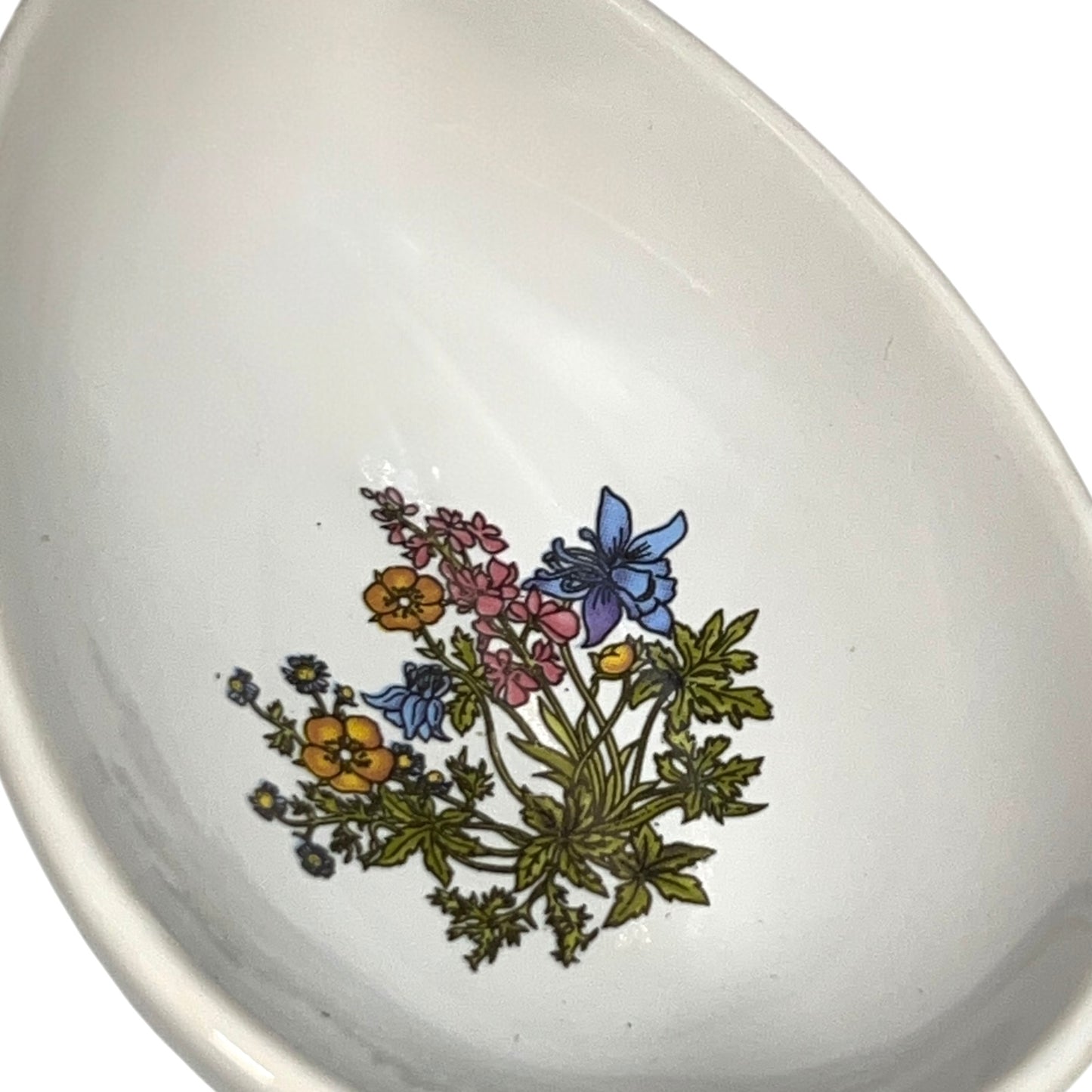 White ceramic bowl with floral design on a white background