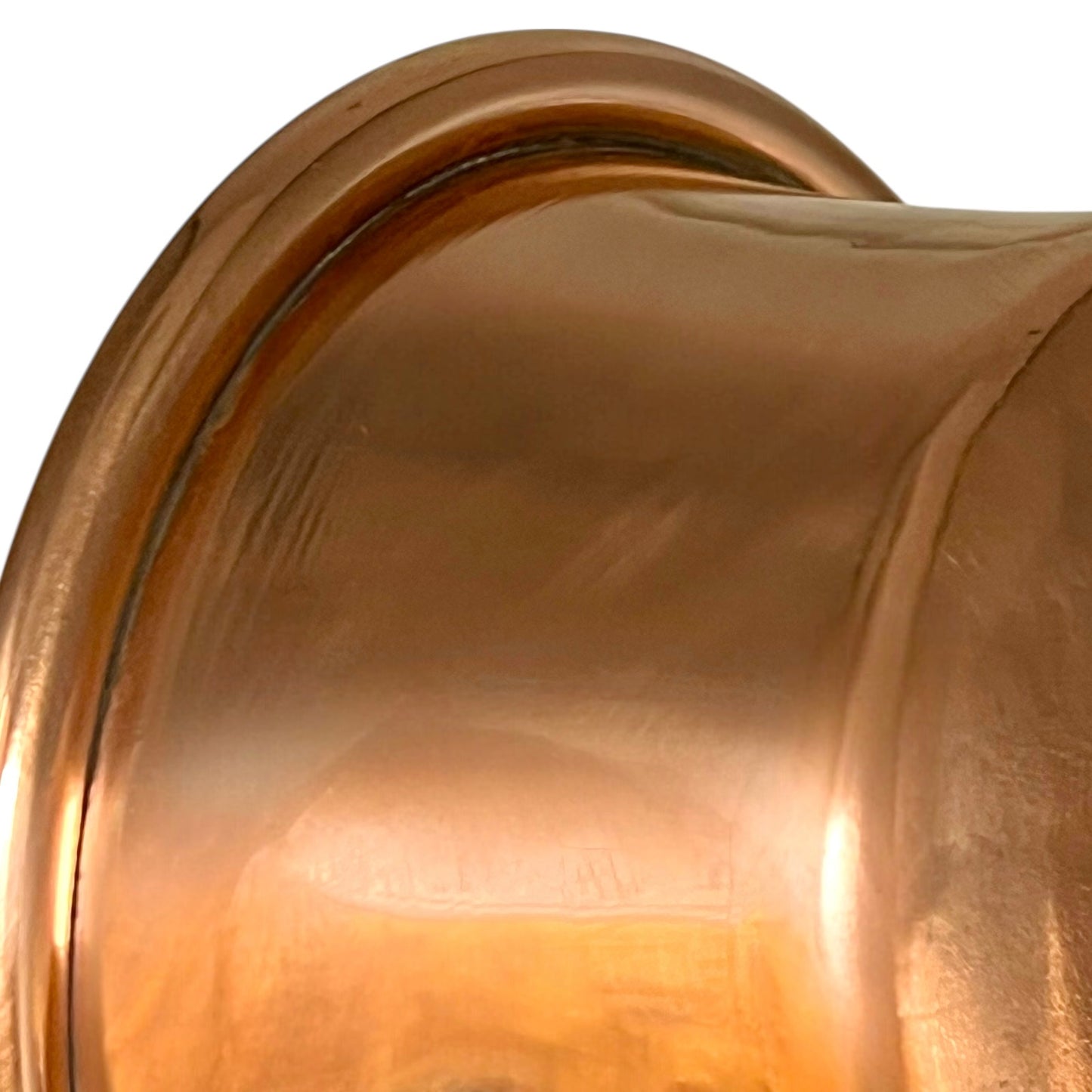 Close-up of a copper pan with a black handle on a white background