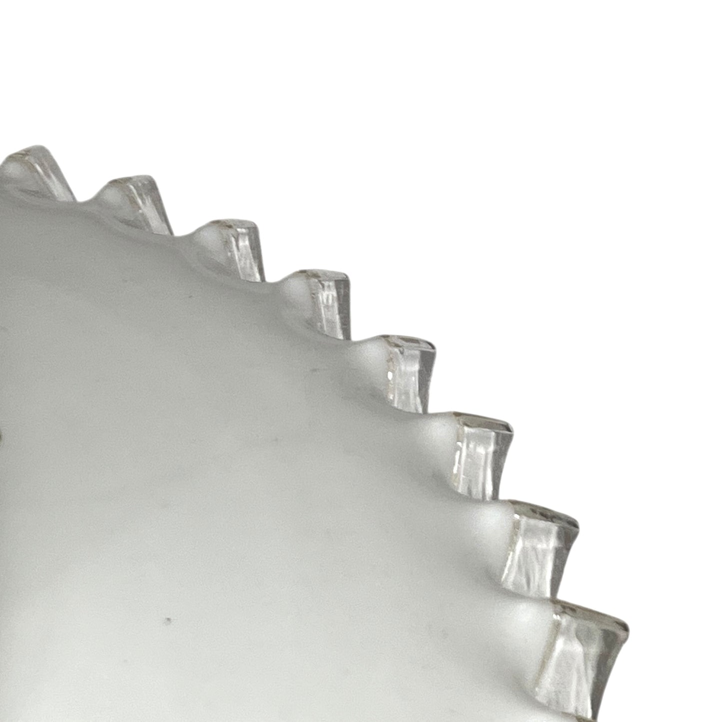 close up of lampshade rim on a white background