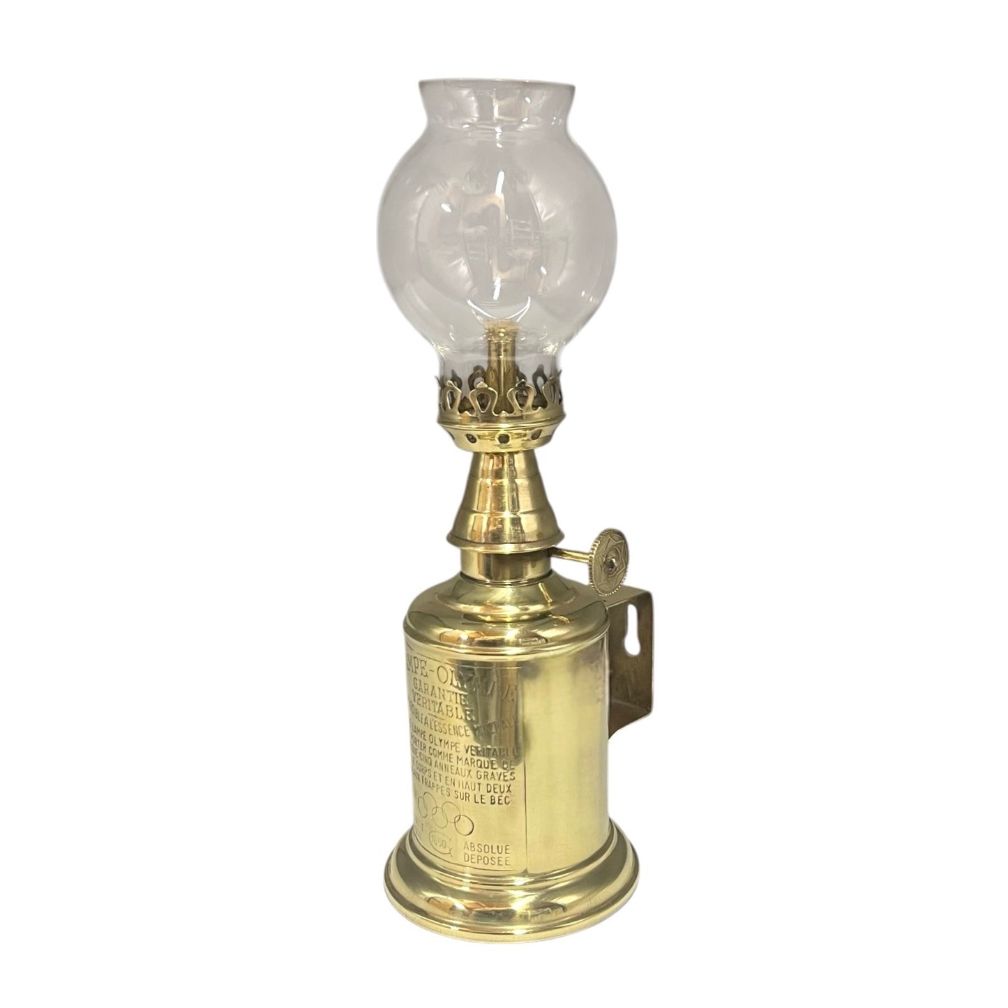 Brass oil lamp with clear glass shade on a white background