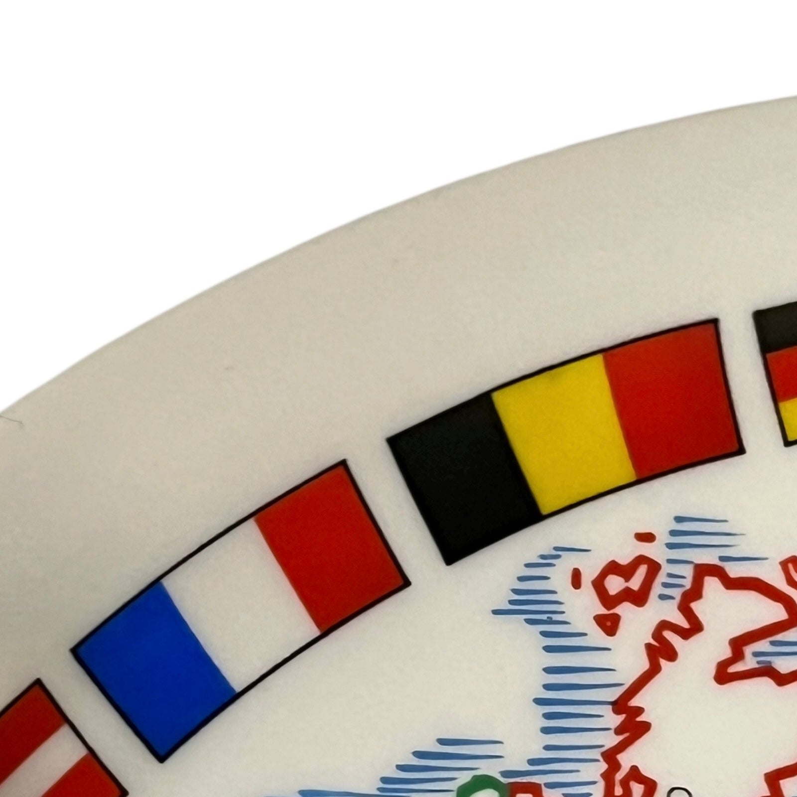 Close-up of a cheeseboard with flags and a map design on a white background