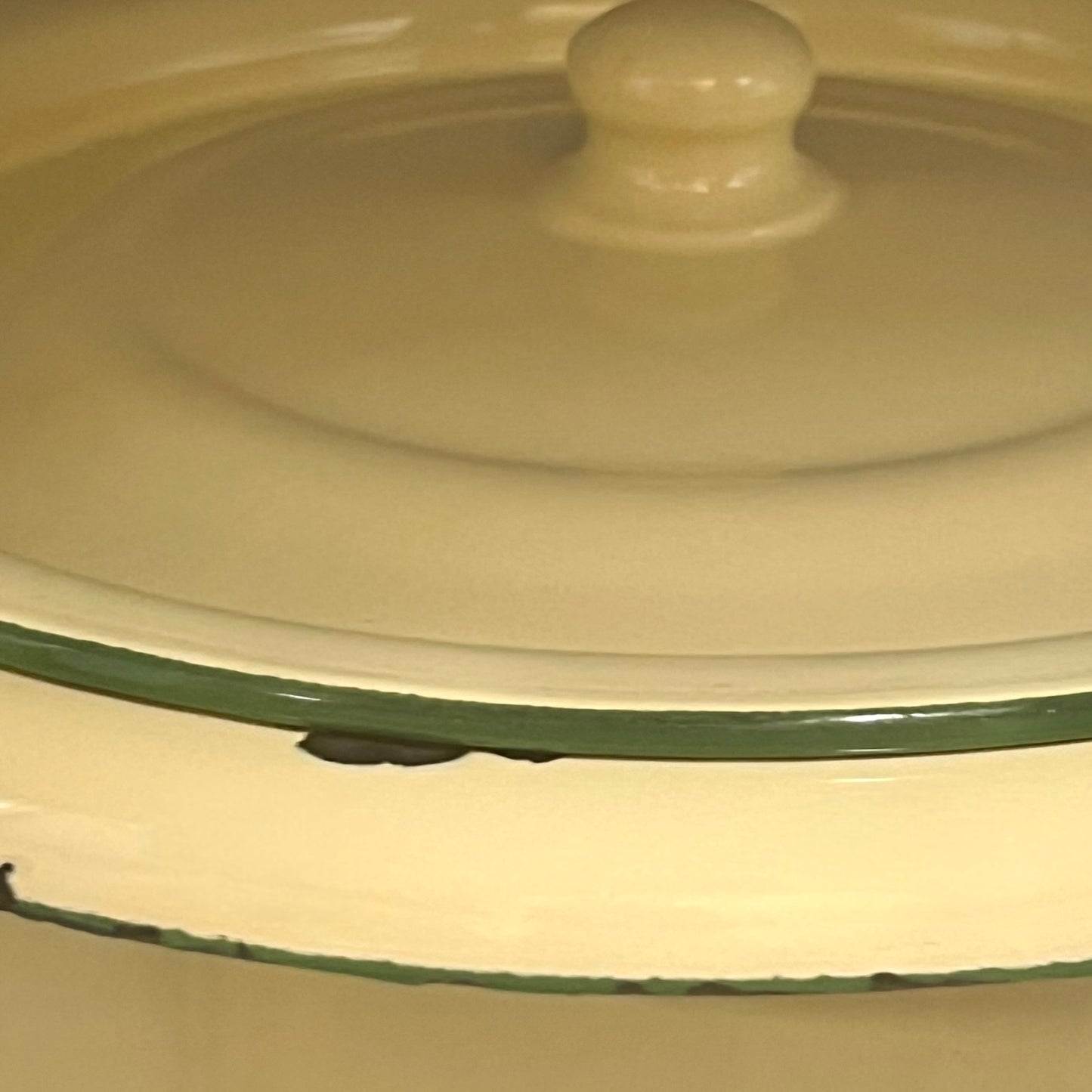 Close up of French vintage cream and green enamel bucket with a lid and handle on a white background