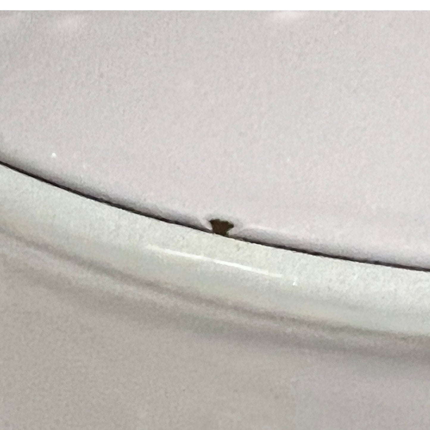 Close up of a Le Creuset pot on a white background