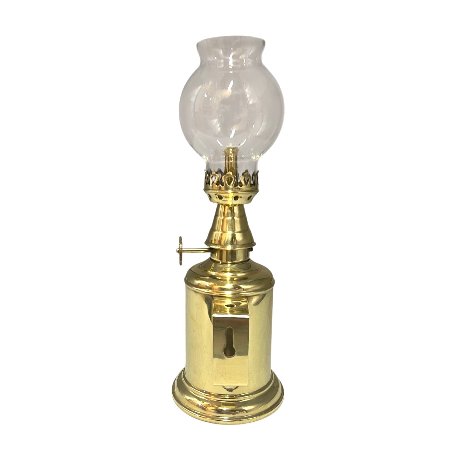 Brass oil lamp with clear glass shade on a white background