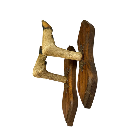Pair of authentic vintage French deer hoof taxidermy coat hooks mounted on individual shaped wooden plaques, displayed on a white background