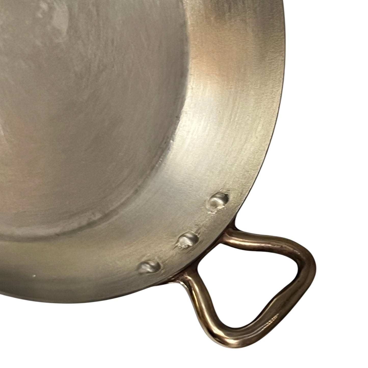 close up of French copper round gratin pan with brass handles and tin lining on a white background