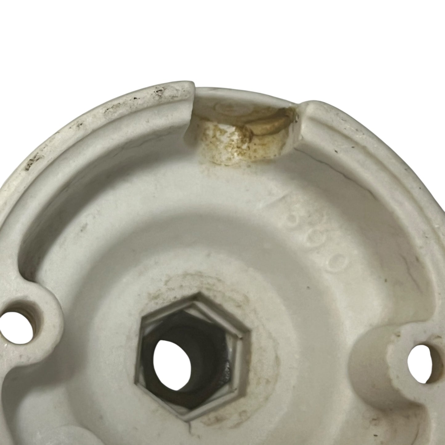 White French porcelain ceiling light rose fitting with a brass screw and 2 screw holes on a white background