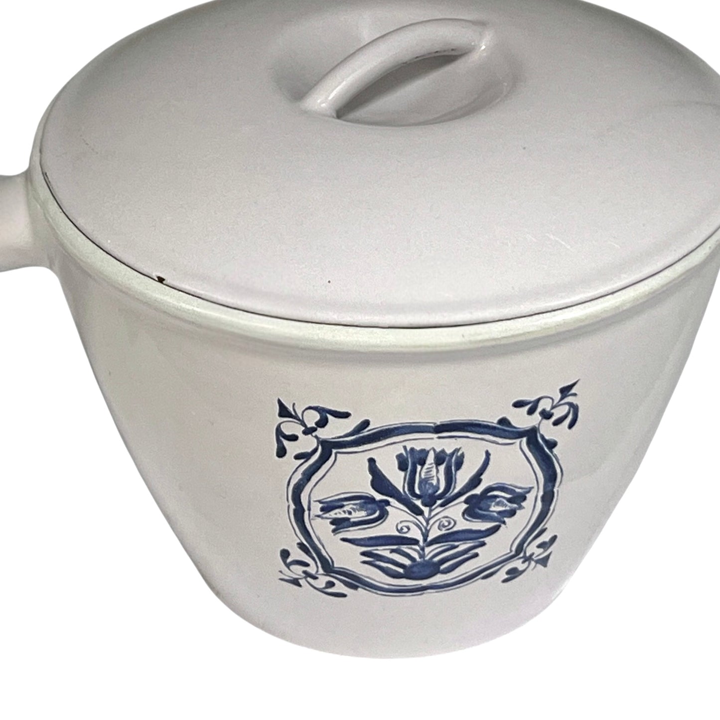 White enamelled cast iron pot with blue floral design and handle on a white background