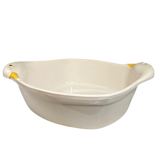 A white ceramic duck-shaped baking dish with side handles, photographed against a plain white background.
