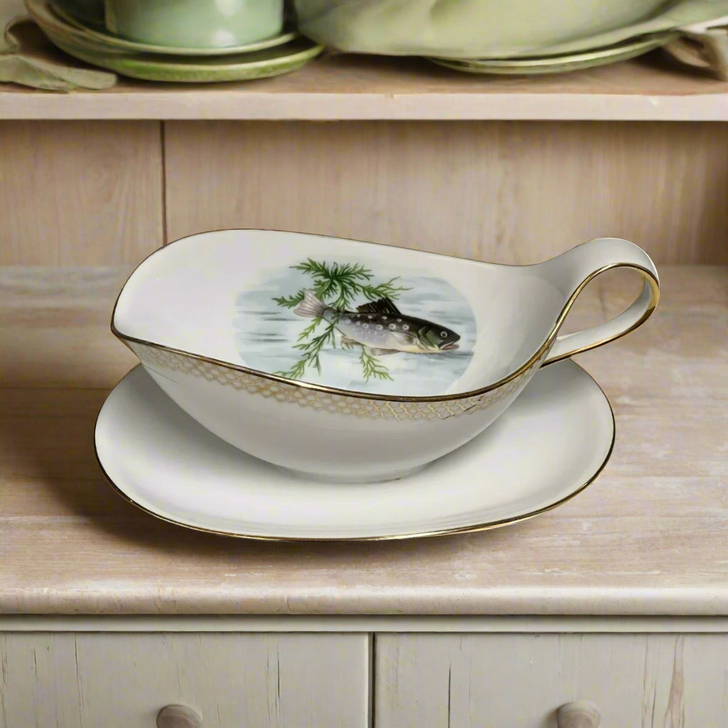 A French vintage porcelain gravy boat with a floral pattern and gold trim, featuring a traditional French fish design for sale from All Things French Store