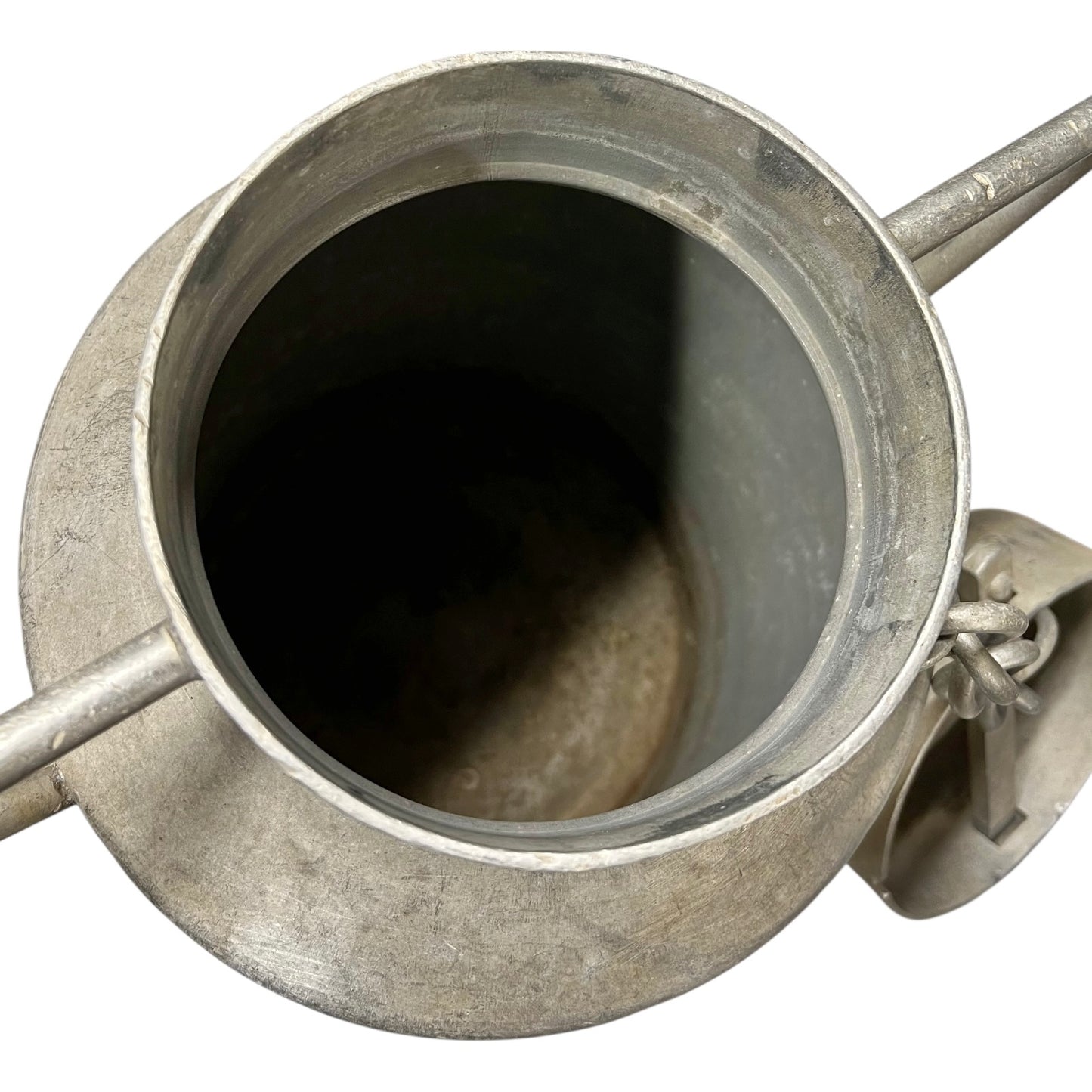 Close-up of a metal container with a dark interior on a white background