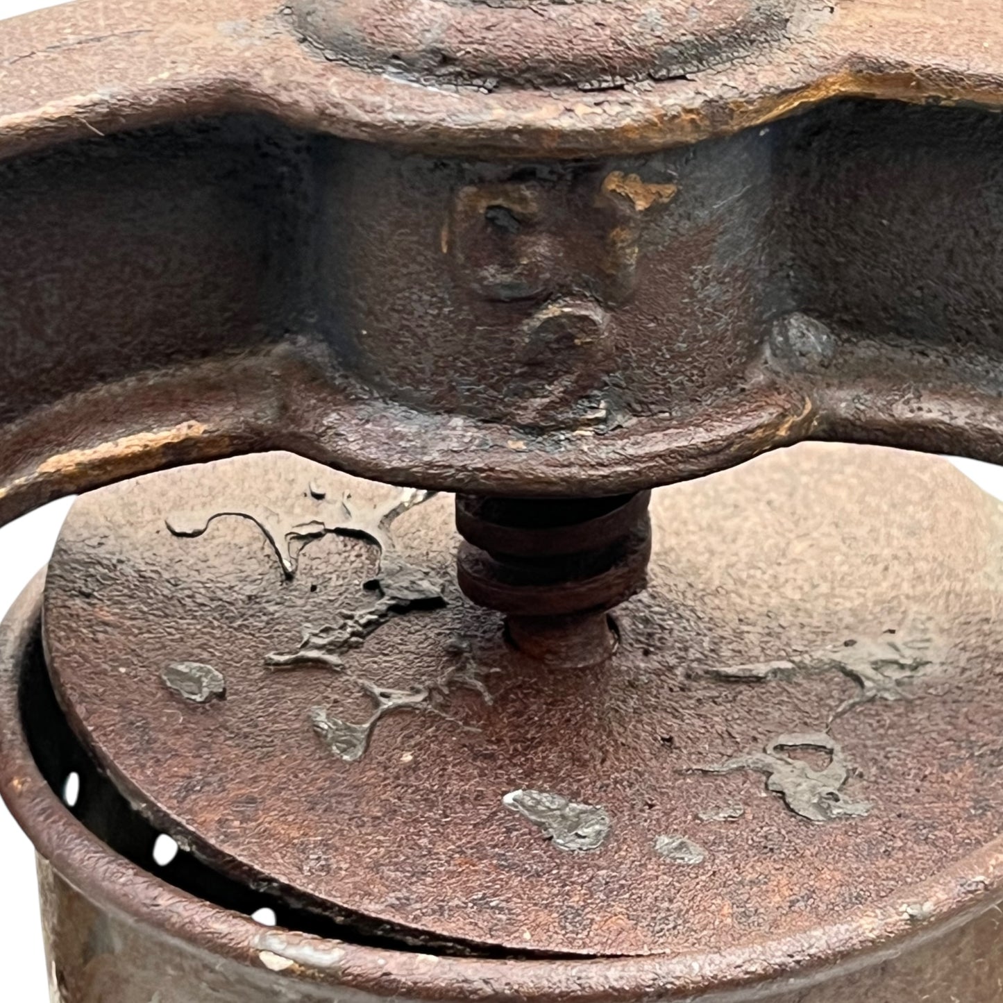 Close-up of a vintage French fruit press with an enamel pot on a white background