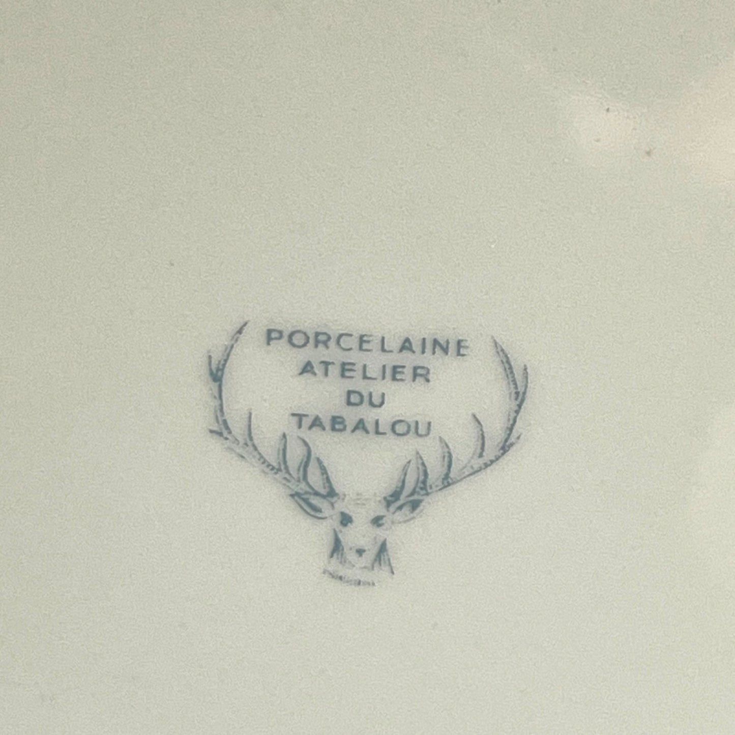 Porcelain mark with deer head design and text on the back of a plate