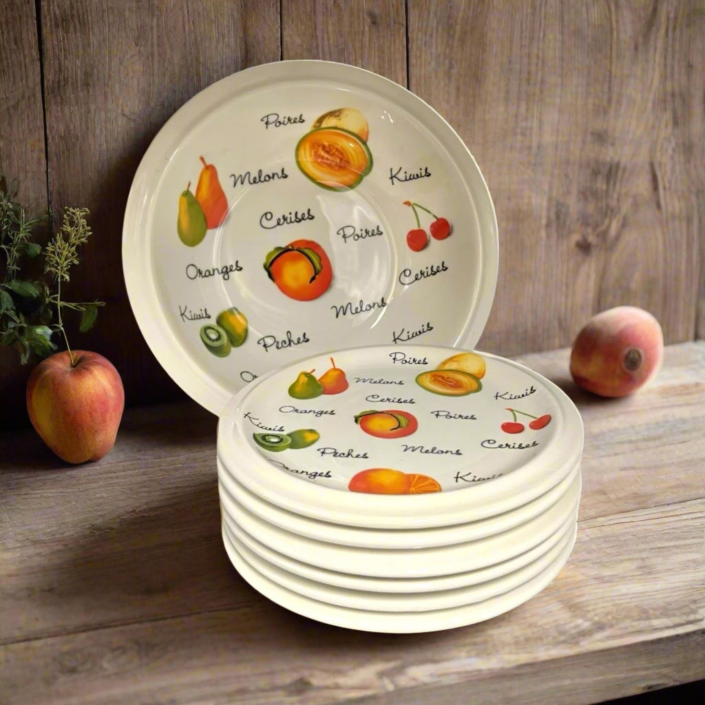 Set of 6 fruit or dessert plates with a larger serving bowl, decorated with fruits and French fruit names on a wooden table