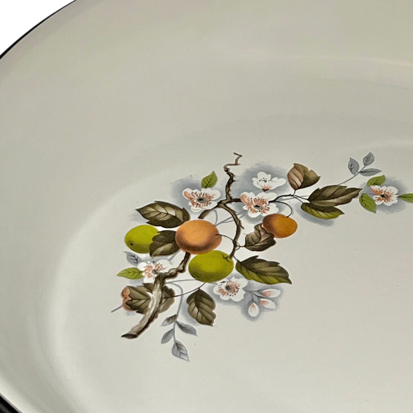Decorative pattern with floral and fruit design in a frying pan on a white background