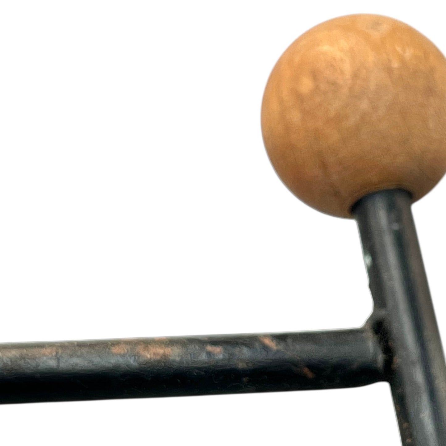 Close-up of a black metal stand on a white background