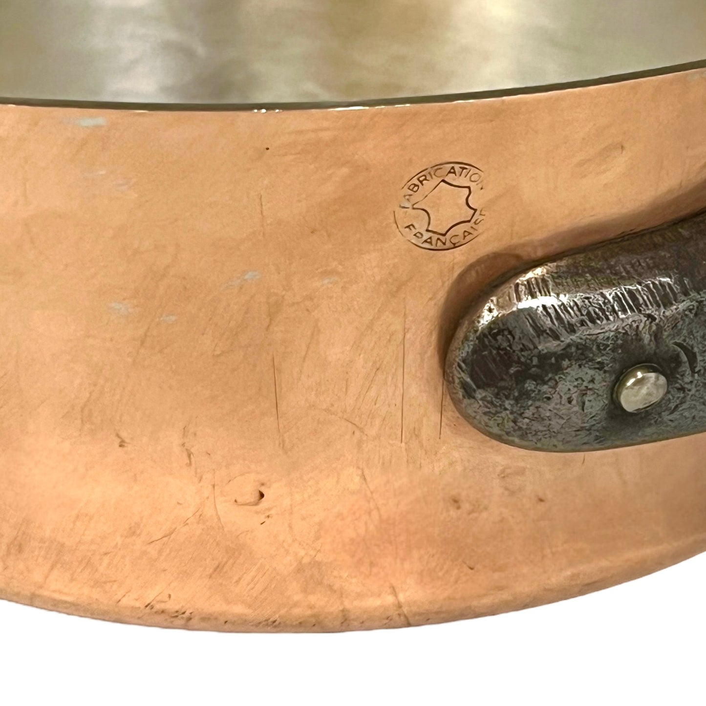 close up image of copper pan makers mark