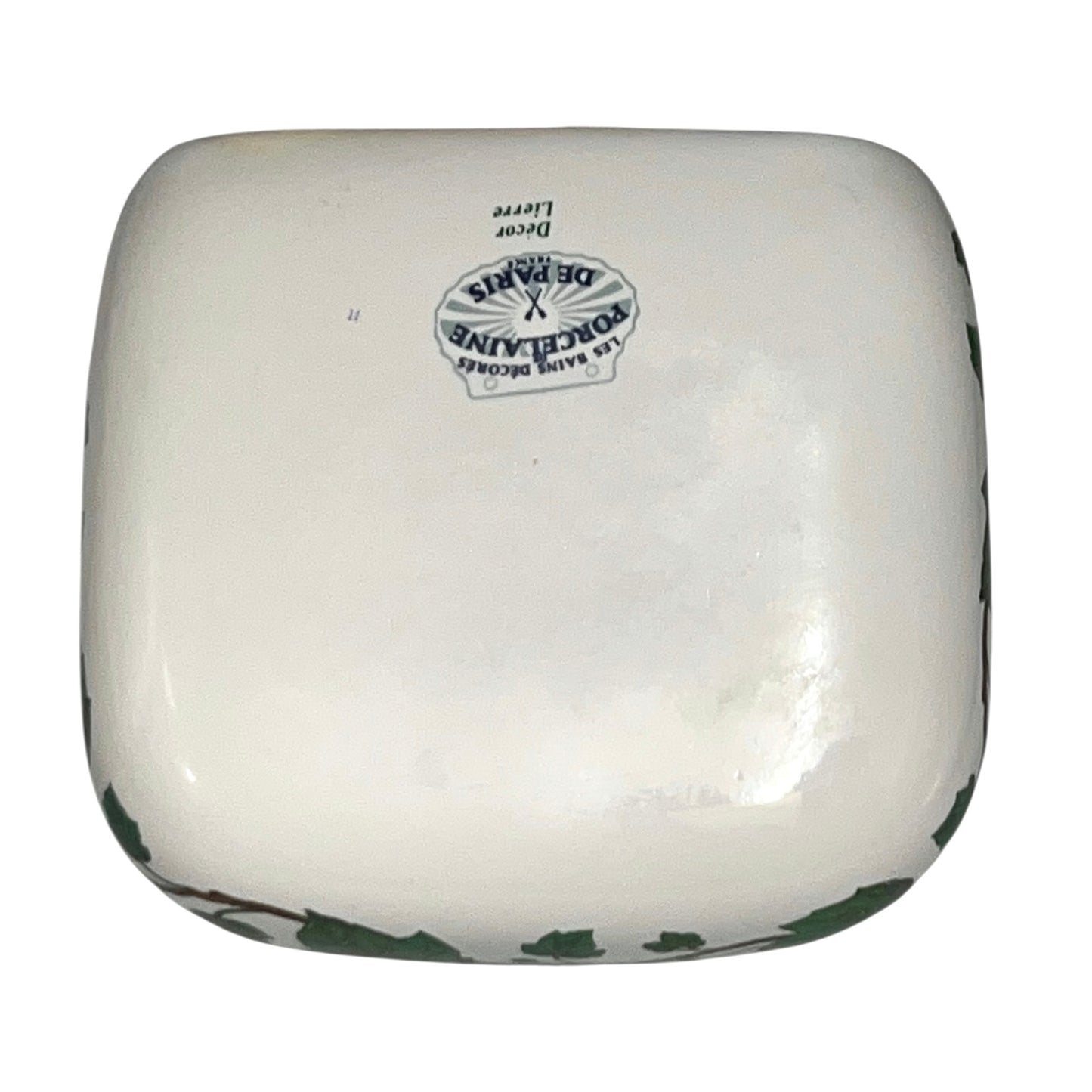 Porcelain bathroom soap dish featuring green leaf patterns on a white background