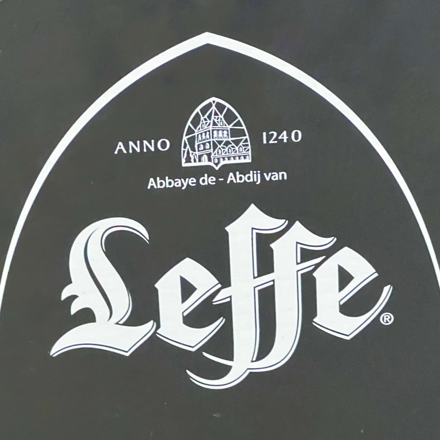 Leffe beer logo with abbey emblem on a black background