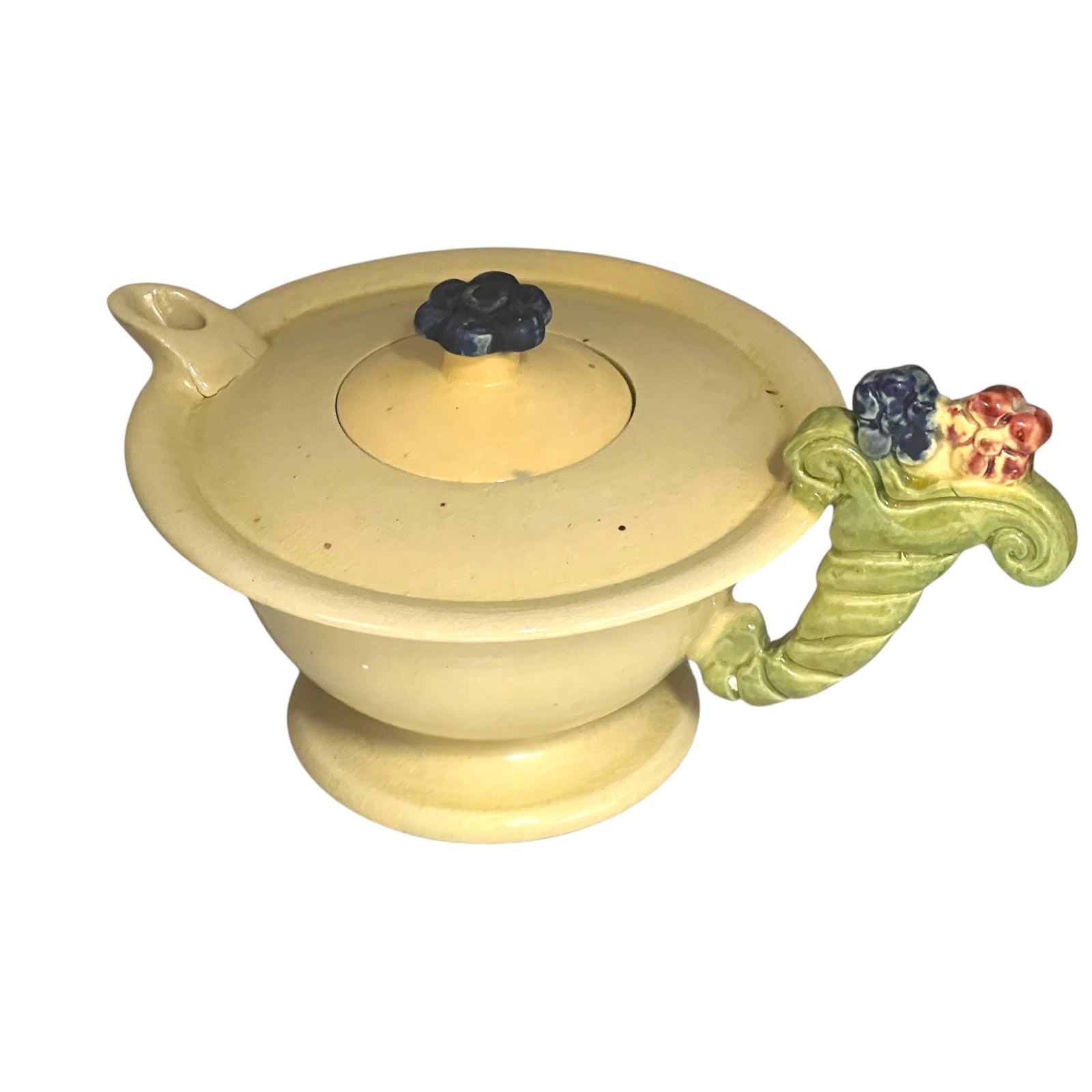 Ceramic teapot with decorative handles on a white background