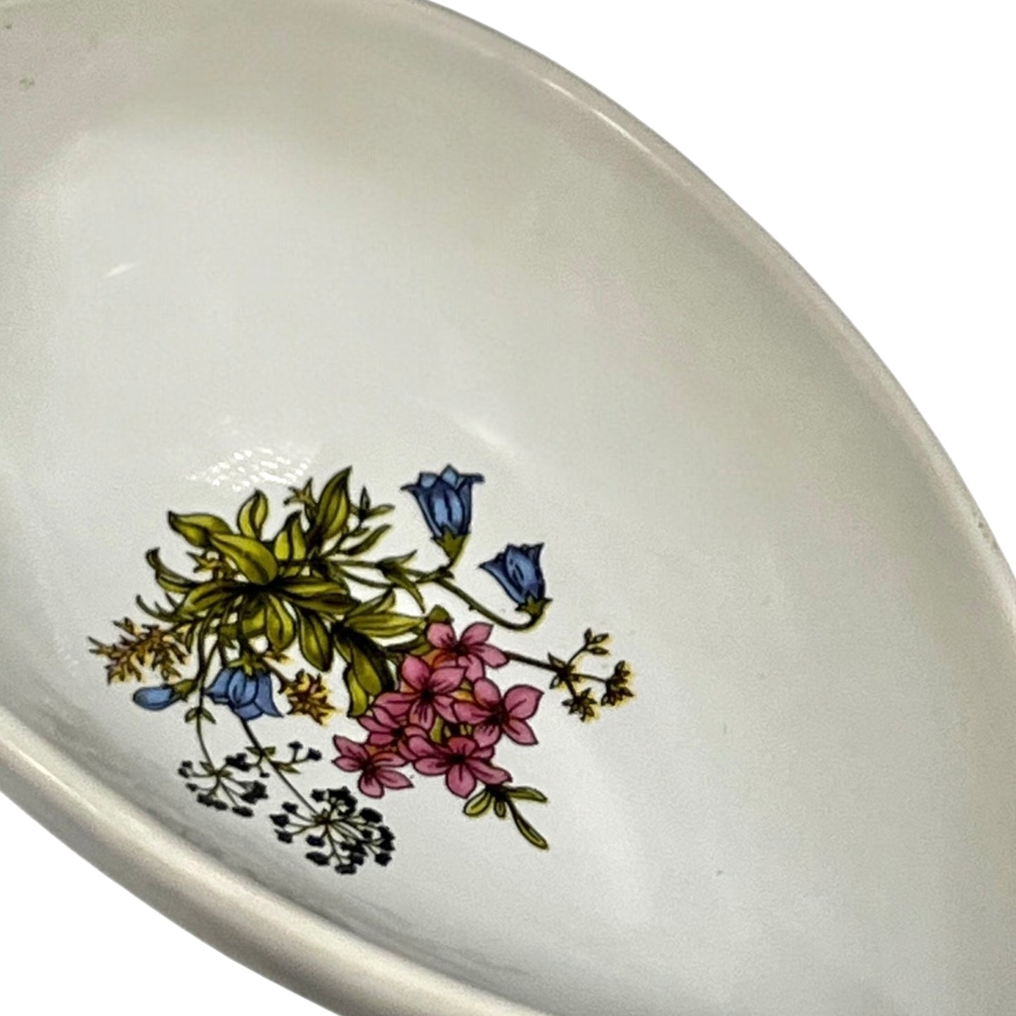 Ceramic avocado dish with floral design on a white background