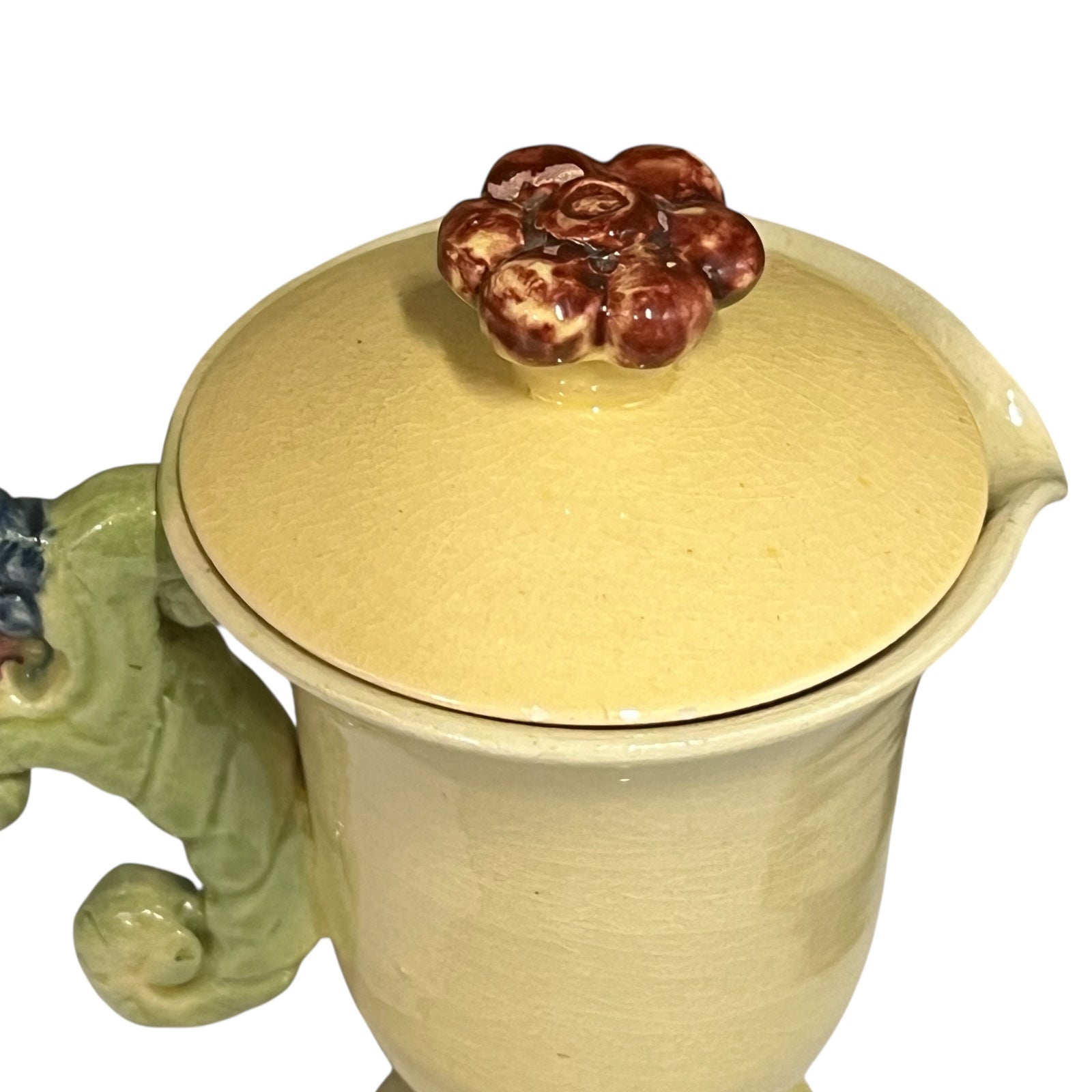 Ceramic mug with a lid and floral design on a white background