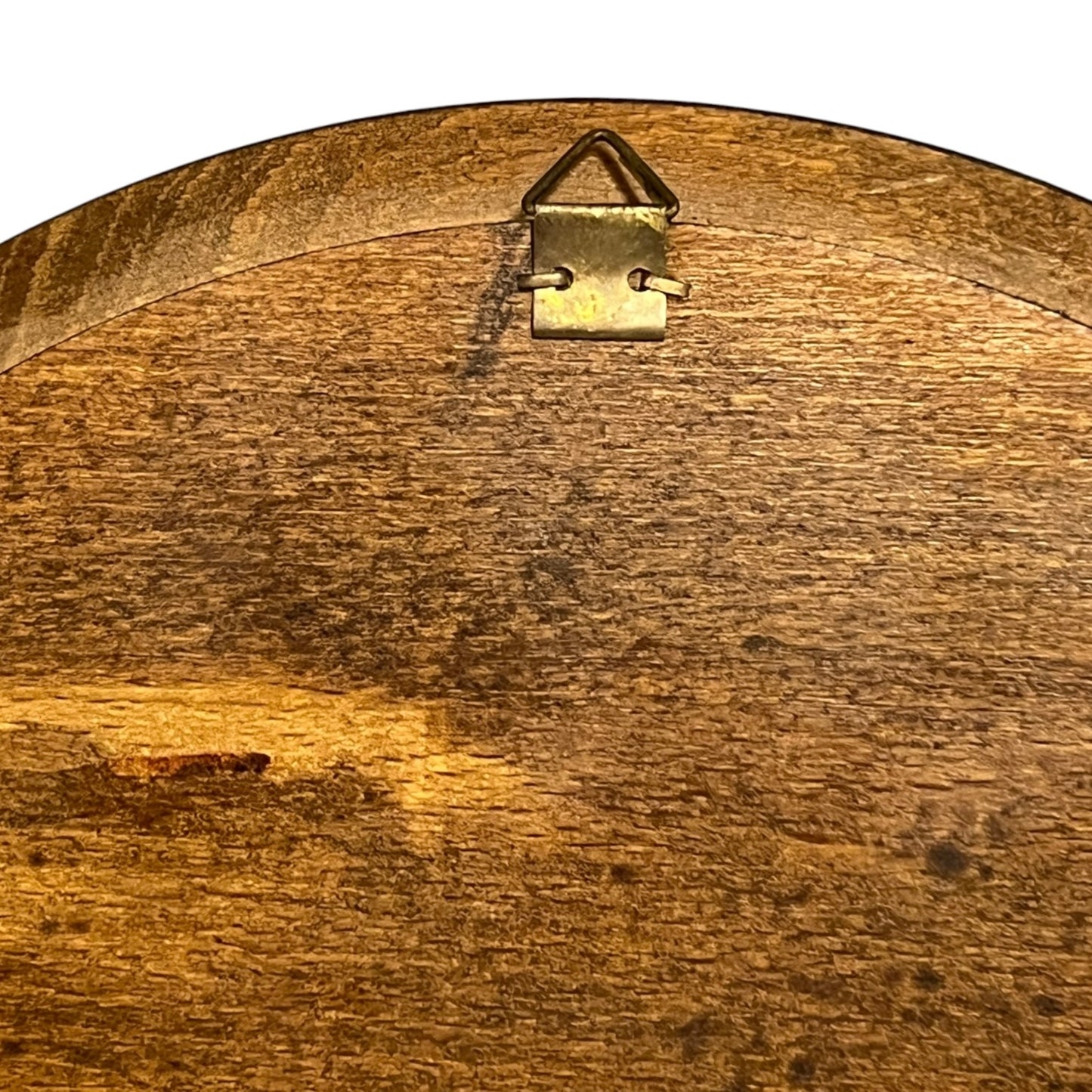 close up of a wooden decorative round plaque on a white background