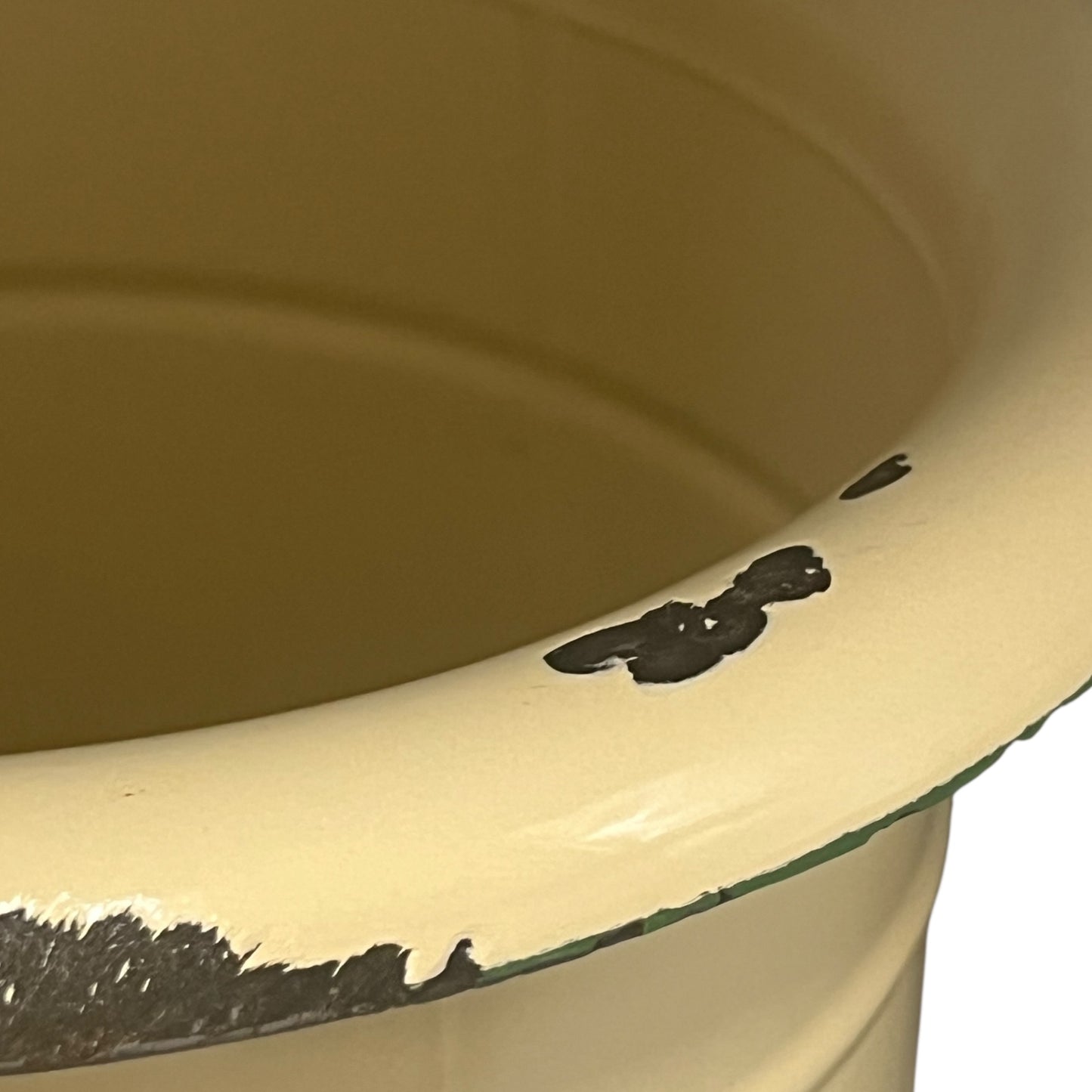 Close up of French vintage cream and green enamel bucket with a lid and handle on a white background