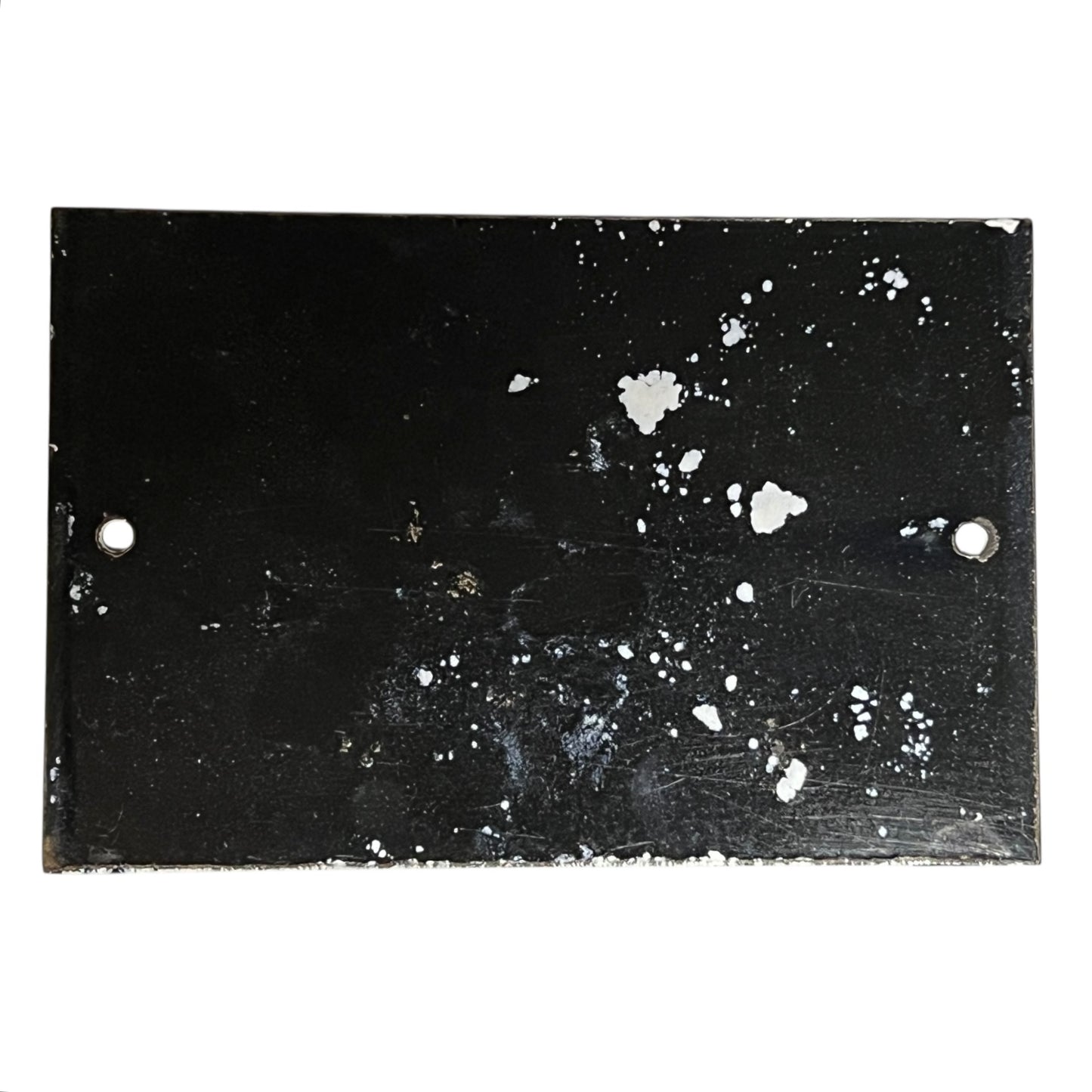 Black surface with white speckles and scratches on a white background