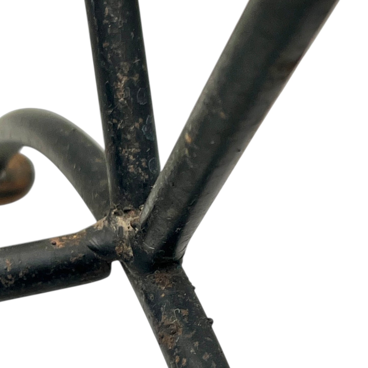Close-up of a black metal stand on a white background