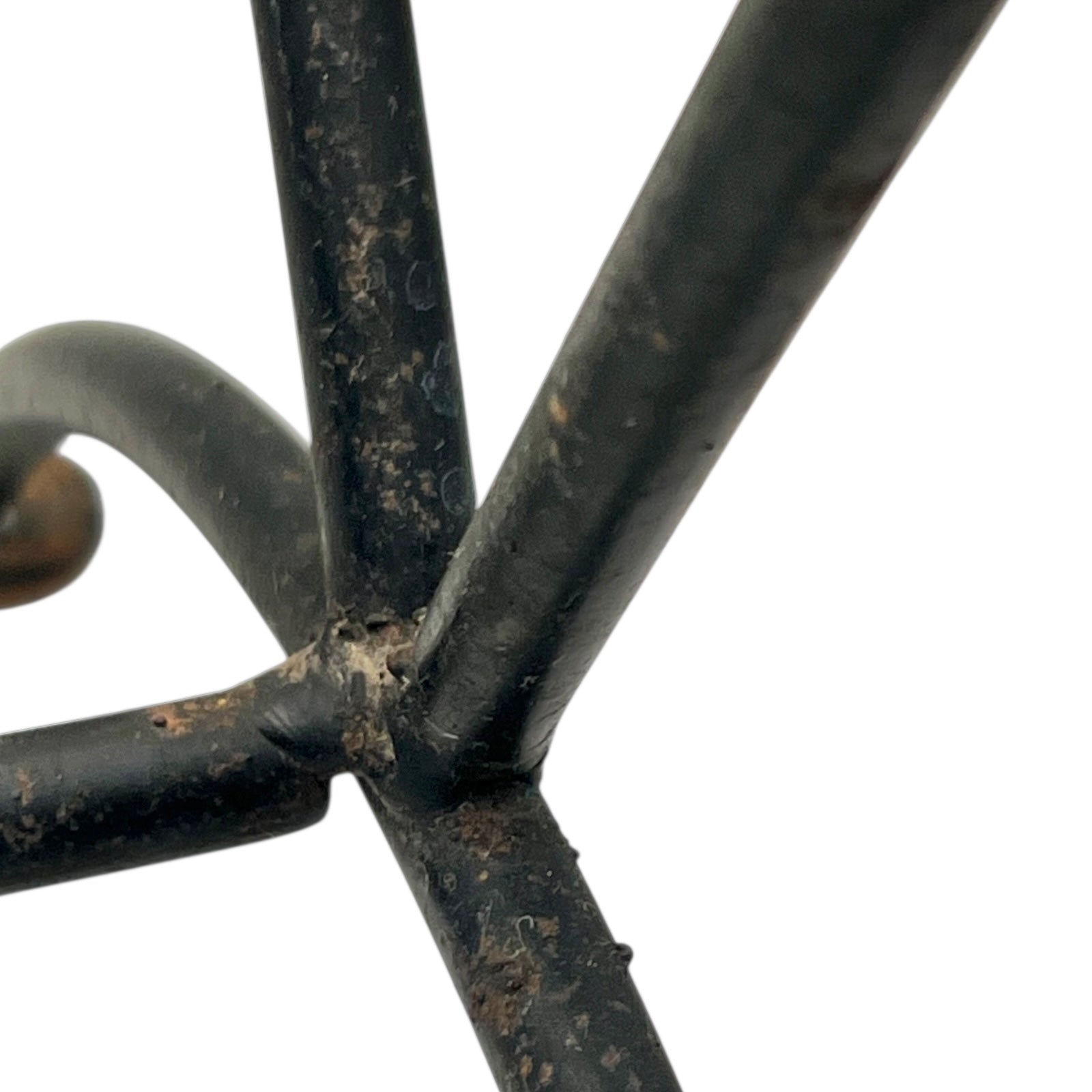 Close-up of a black metal stand on a white background