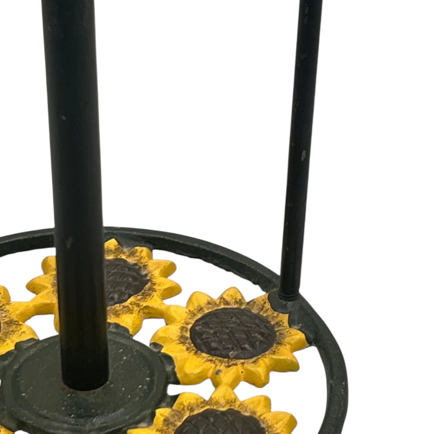 Black metal kitchen paper towel stand with sunflower designs on a white background