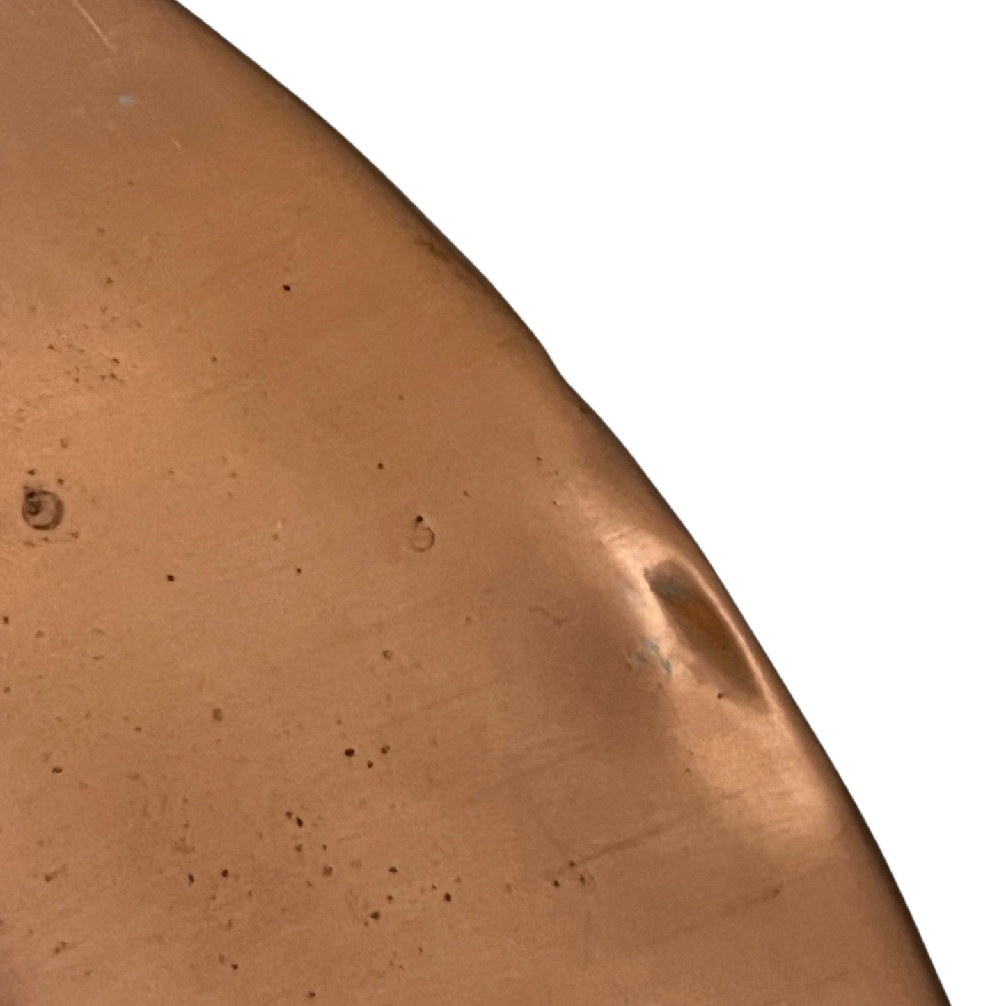Close-up of a copper pan lid on a white background
