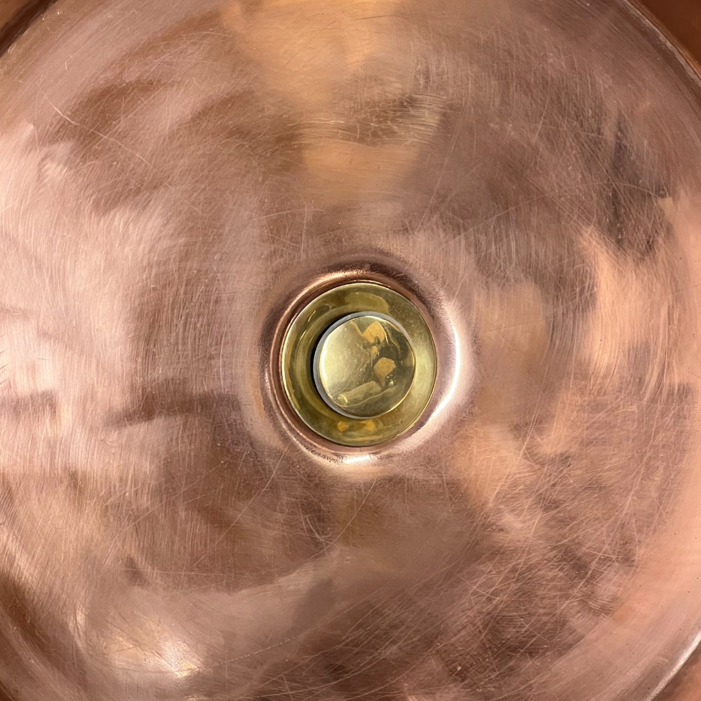 Close-up of copper sink with brass pop up waste