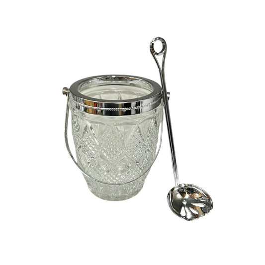 Clear glass ice bucket with silver scoop and handle on a white background