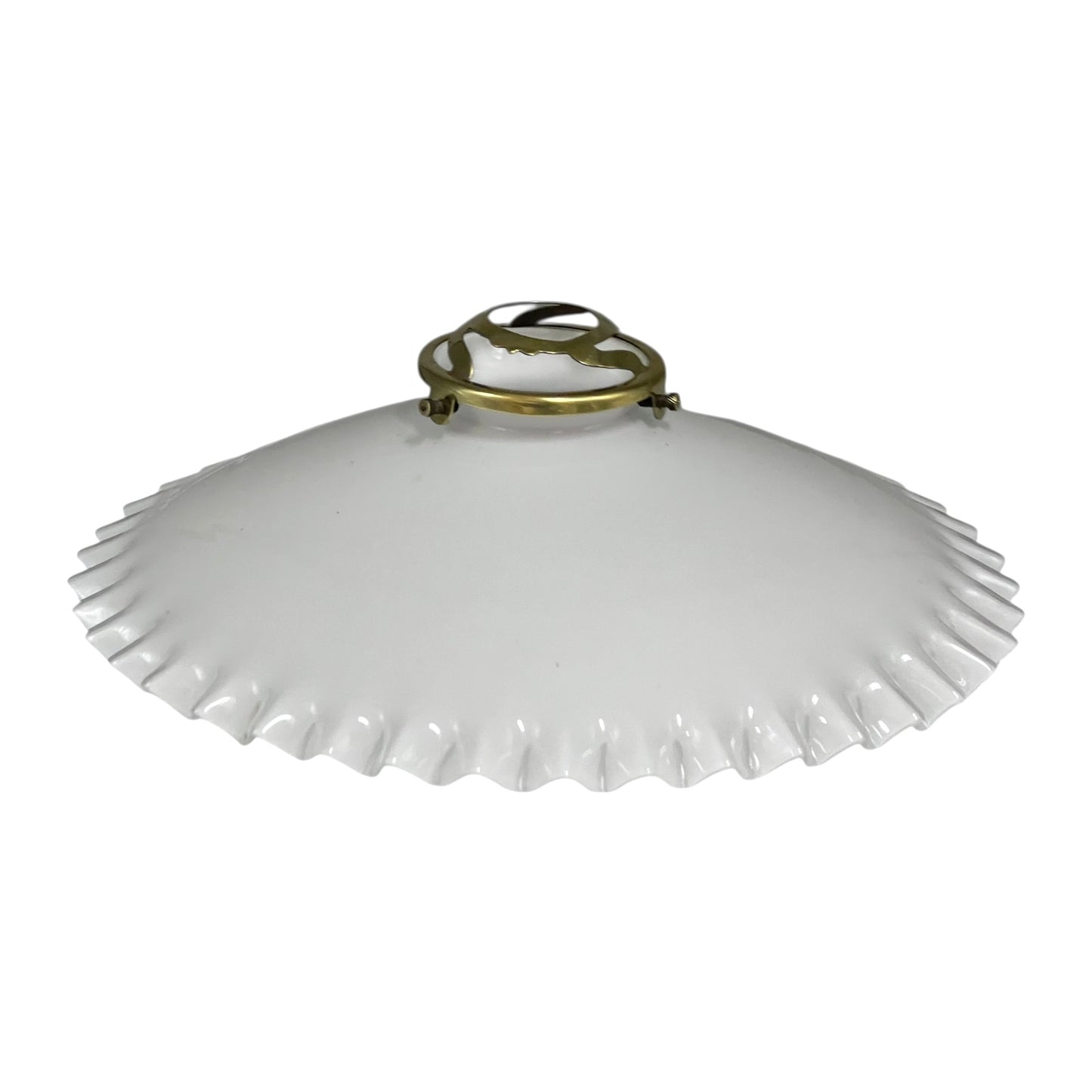 White scalloped-edge lampshade with brass fixture on a white background