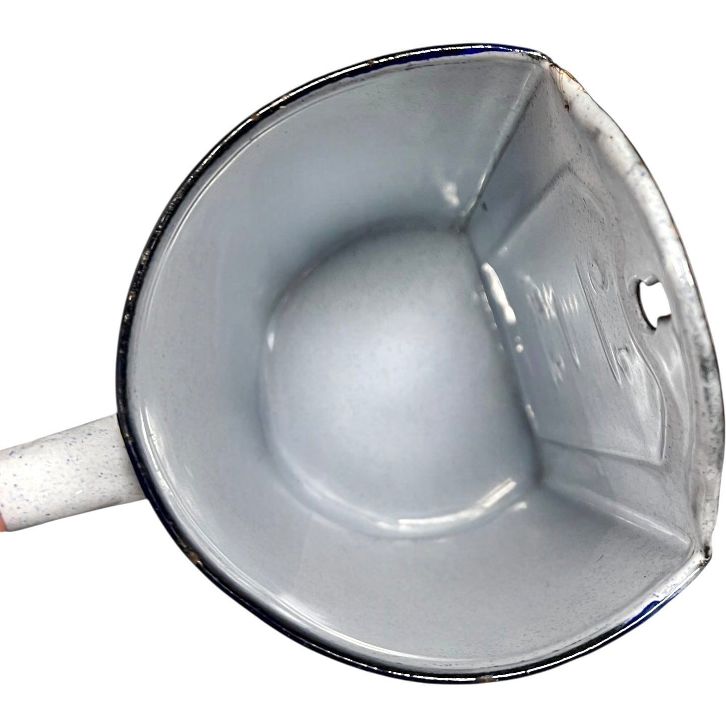 Close-up of the inside of an enamel planter with speckled glaze and blue rim on a white background