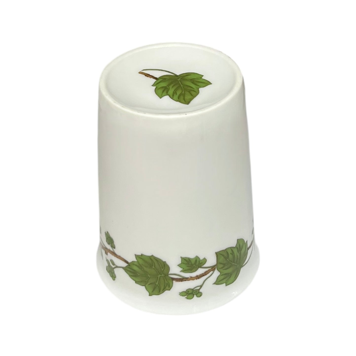 Porcelain bathroom tumbler featuring green leaf patterns on a white background