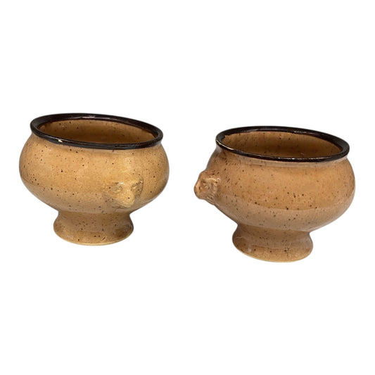 Two brown ceramic pots on a white background