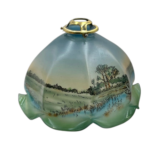 Decorative glass light fixture with landscape design on a white background