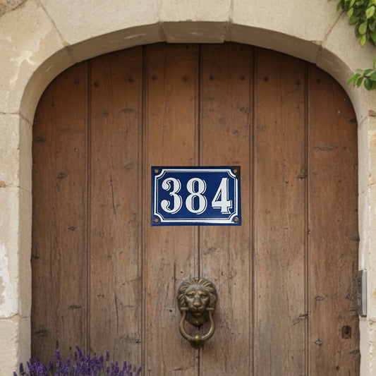 Wooden door with a blue house number sign '384' and a lion knocker.