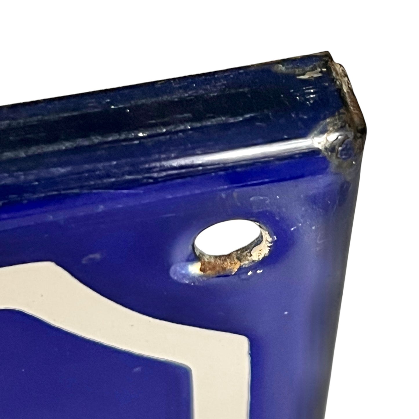 Close-up of a blue and white sign on a white background