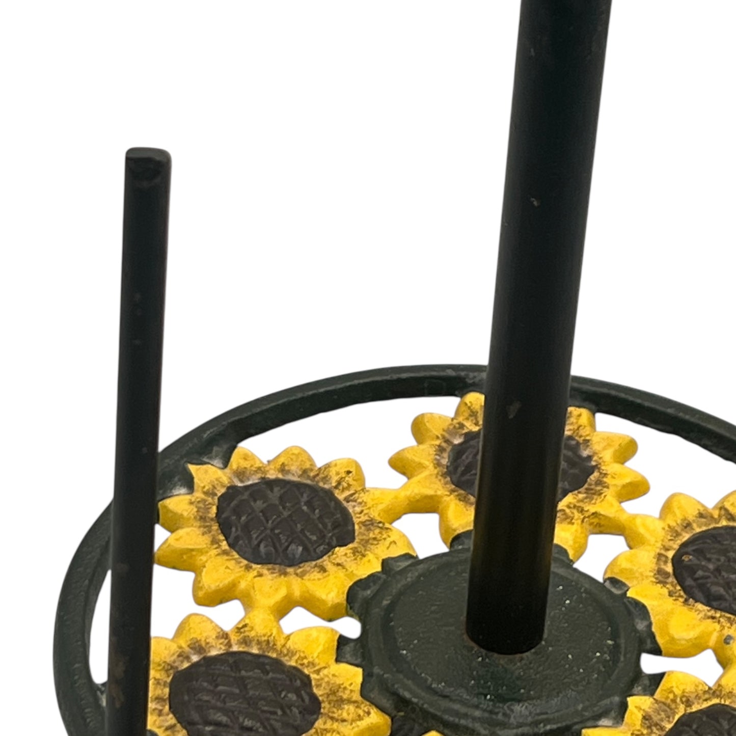 Black metal rustic kitchen roll holder stand with sunflower designs on a white background