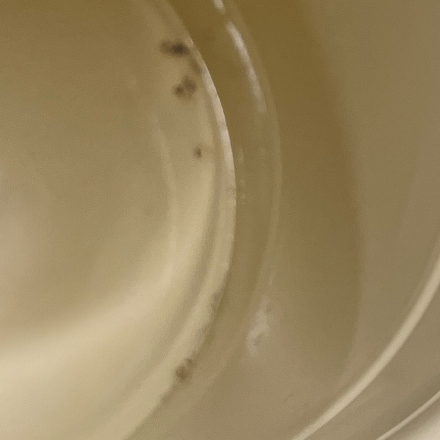 Close up of French vintage cream and green enamel bucket with a lid and handle on a white background